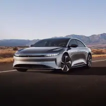 A Cosmos silver metallic Lucid Air Touring driving in the foothills.