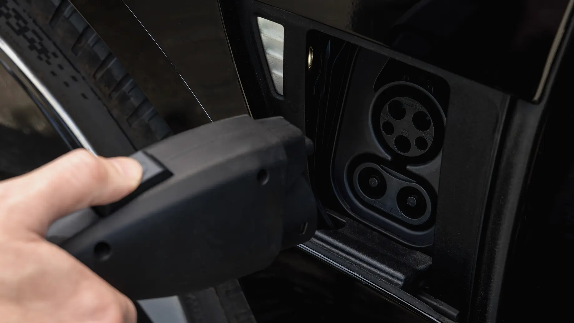 Charger being plugged into charge port
